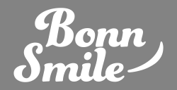Born Smile script logo on gray background